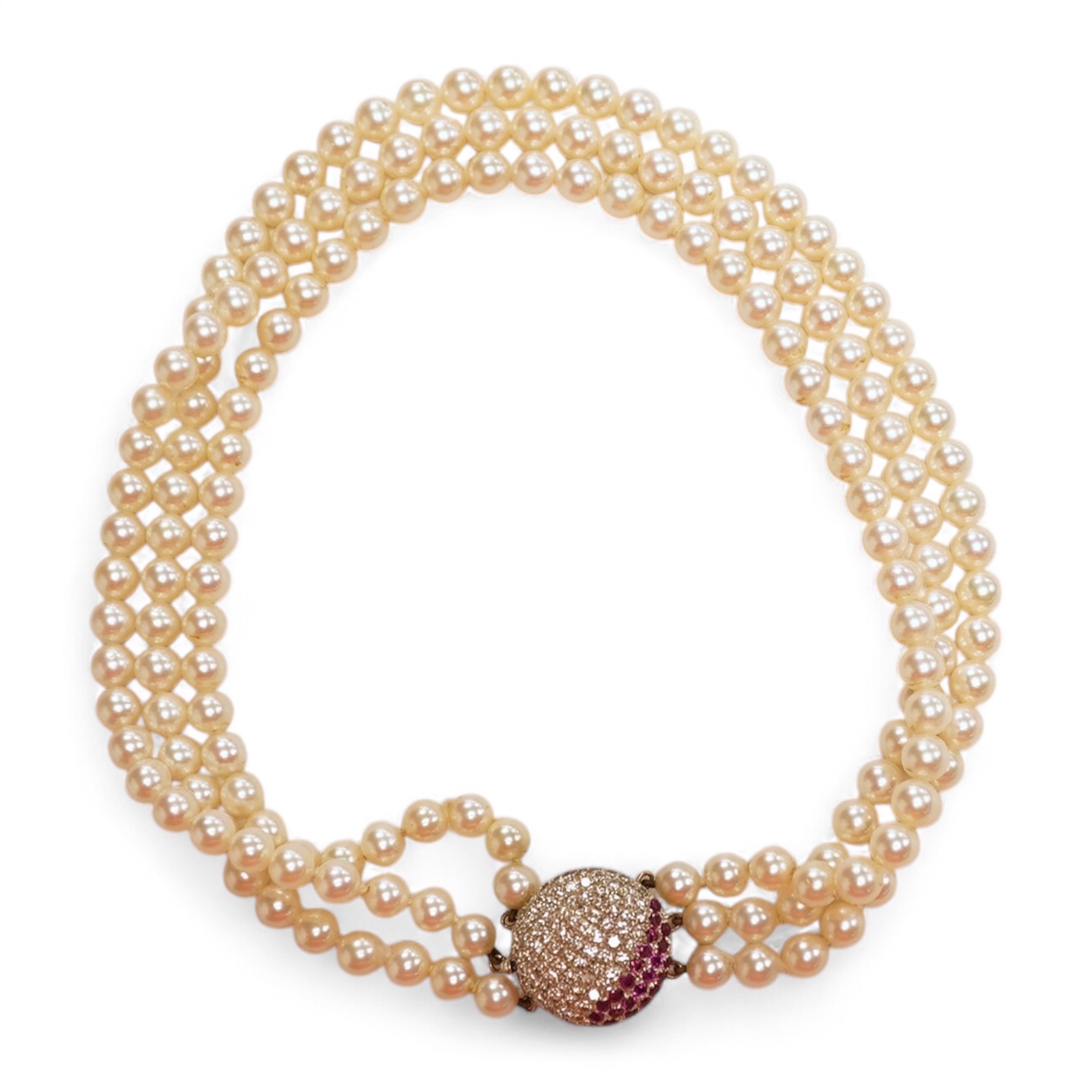 A cultured pearl, ruby and diamond clasp, composed of three rows of cultured pearls measuring approximately 6.9mm diameter, to a white precious metal (tests as 14k) disc-shaped clasp pavé-set with brilliant-cut diamonds